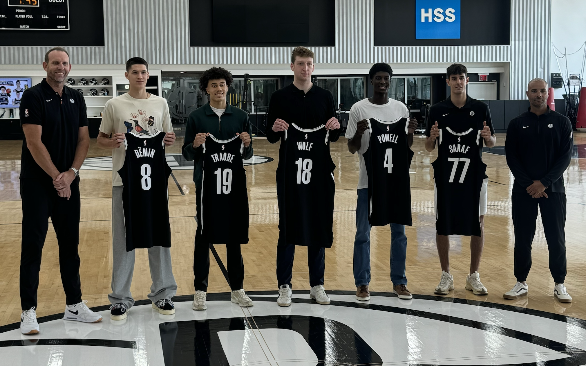Brooklyn Nets general manager Sean Marks (left), and head coach Jordi Fernandez (right) pose with the team's recruit at the HSS Training Center.